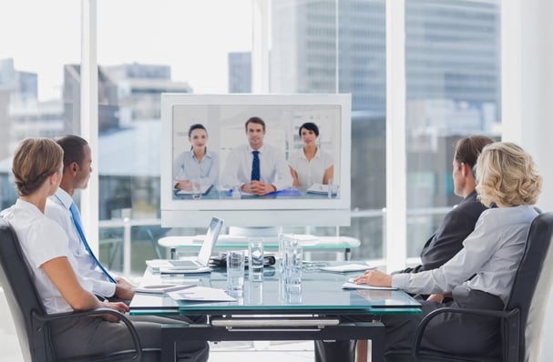 Business team having video conference with another business team in office.jpeg